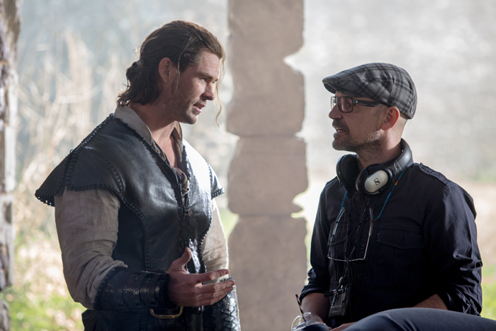 (L to R) CHRIS HEMSWORTH as Eric the Huntsman and director CEDRIC NICOLAS-TROYAN on the set of "The Huntsman: Winter’s War," the story that came before Snow White. Hemsworth and Oscar® winner Charlize Theron return to their roles from "Snow White and the Huntsman," joined by Emily Blunt and Jessica Chastain.
