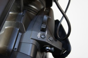 Focus Mag button on the handgrip of the PXW-Z100.