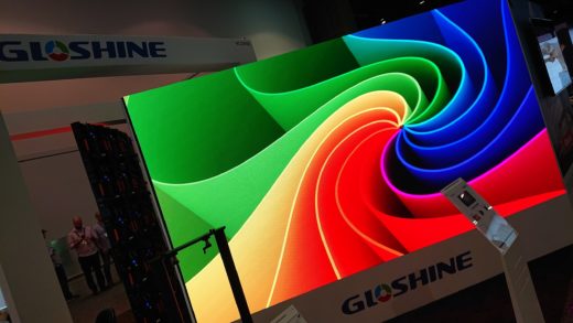 LED video wall on a trade show floor with a brightly-coloured abstract graphic