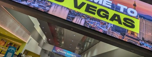 A large sign reading "welcome to Las Vegas" in the central hall lobby of the Las Vegas Convention Center.