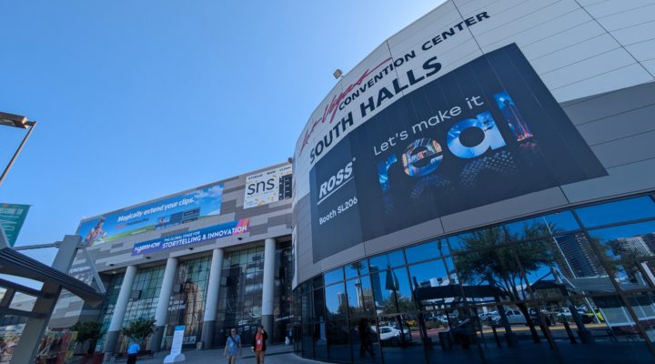 A wide angle view looking up at the South Hall of the Las Vegas Convention Center, showing hoardings advertising exhibitors at the 2025 NAB Show.