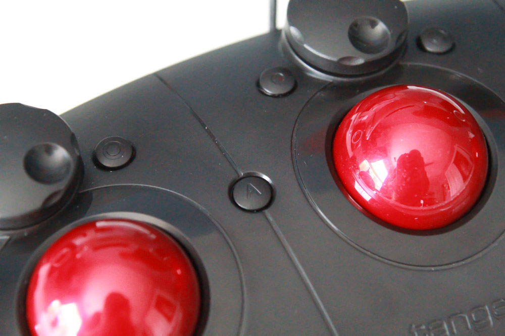 An A and B button between the trackerballs adds additional functionality.