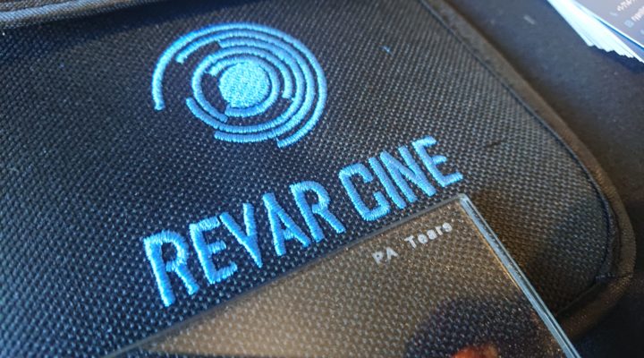 Closeup of a camera filter marked PA Tears lying on a Revar Cine filter pouch. Reflective flakes are visible in the structure of the filter.