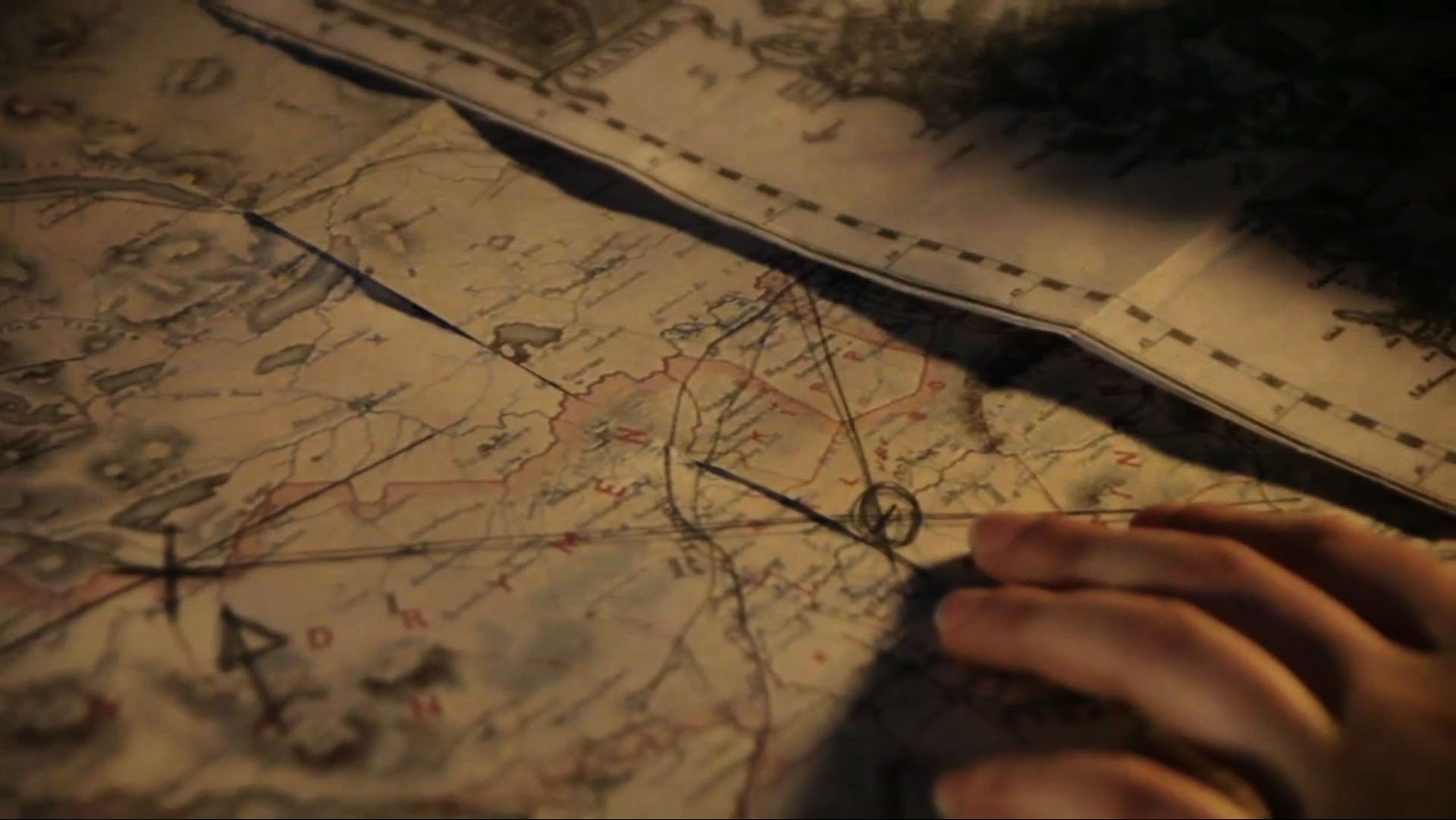 Closeup of a woman's hand as she examines an old map.