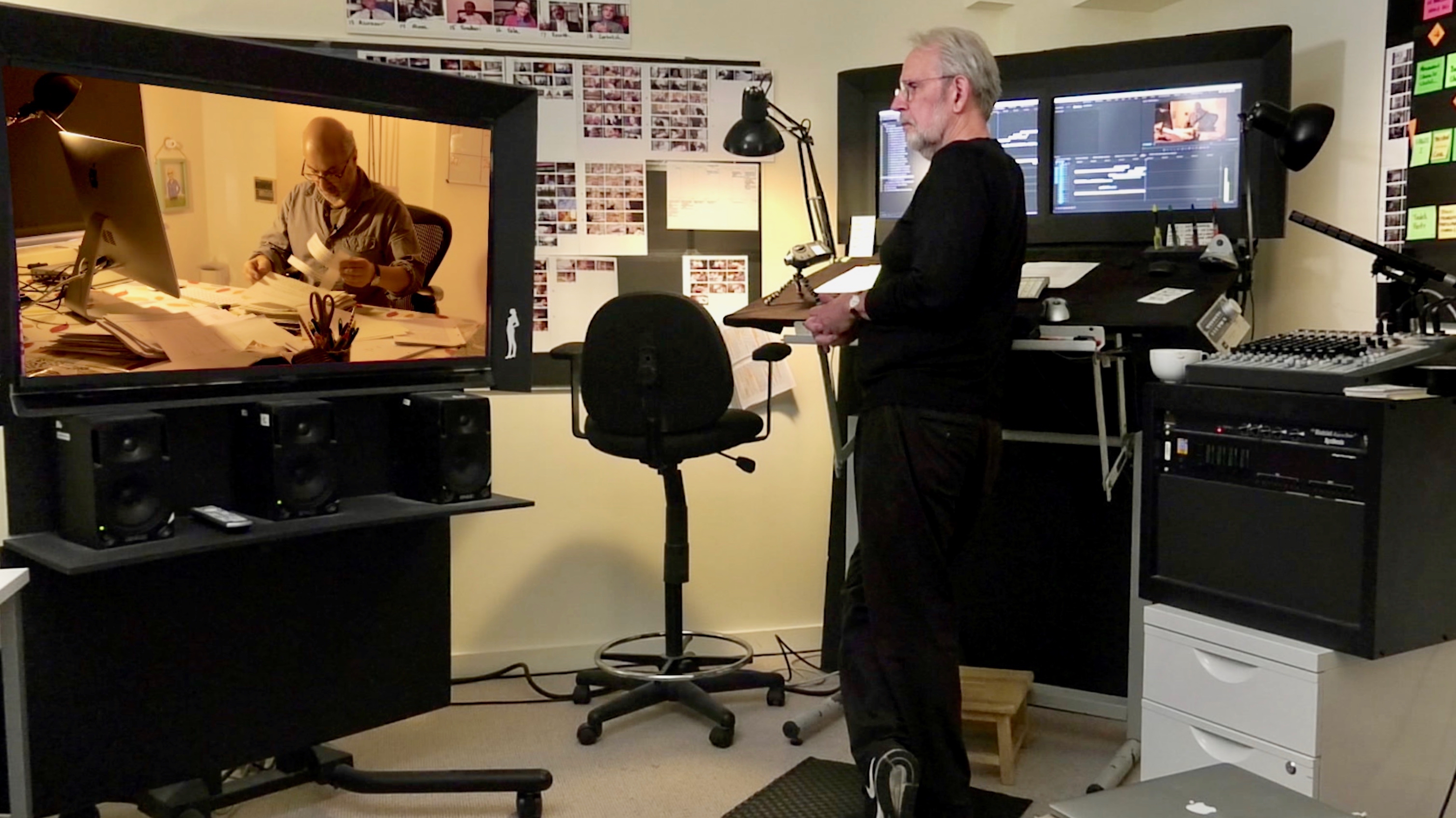 Walter Murch stands at his editing table, watching a scene from his latest documentary, Coup 53.