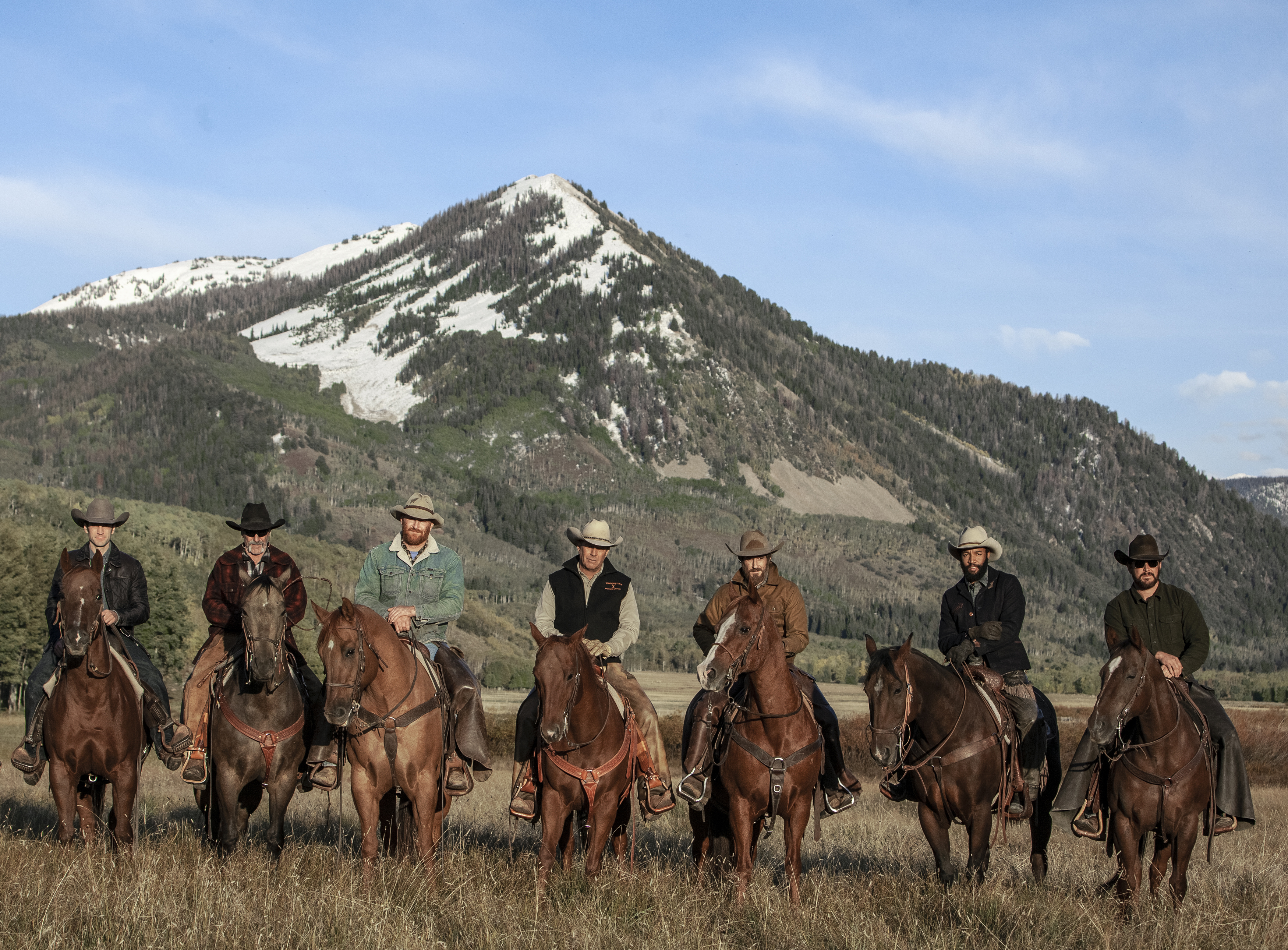 John Dutton (center - Kevin Costner), owner of the Dutton Ranch is surround...