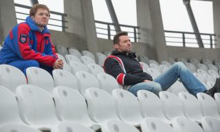 Eddie (Taron Egerton) and his coach Bronson (Hugh Jackman) contemplate Eddie’s “impossible” dream of competing at the Olympics.