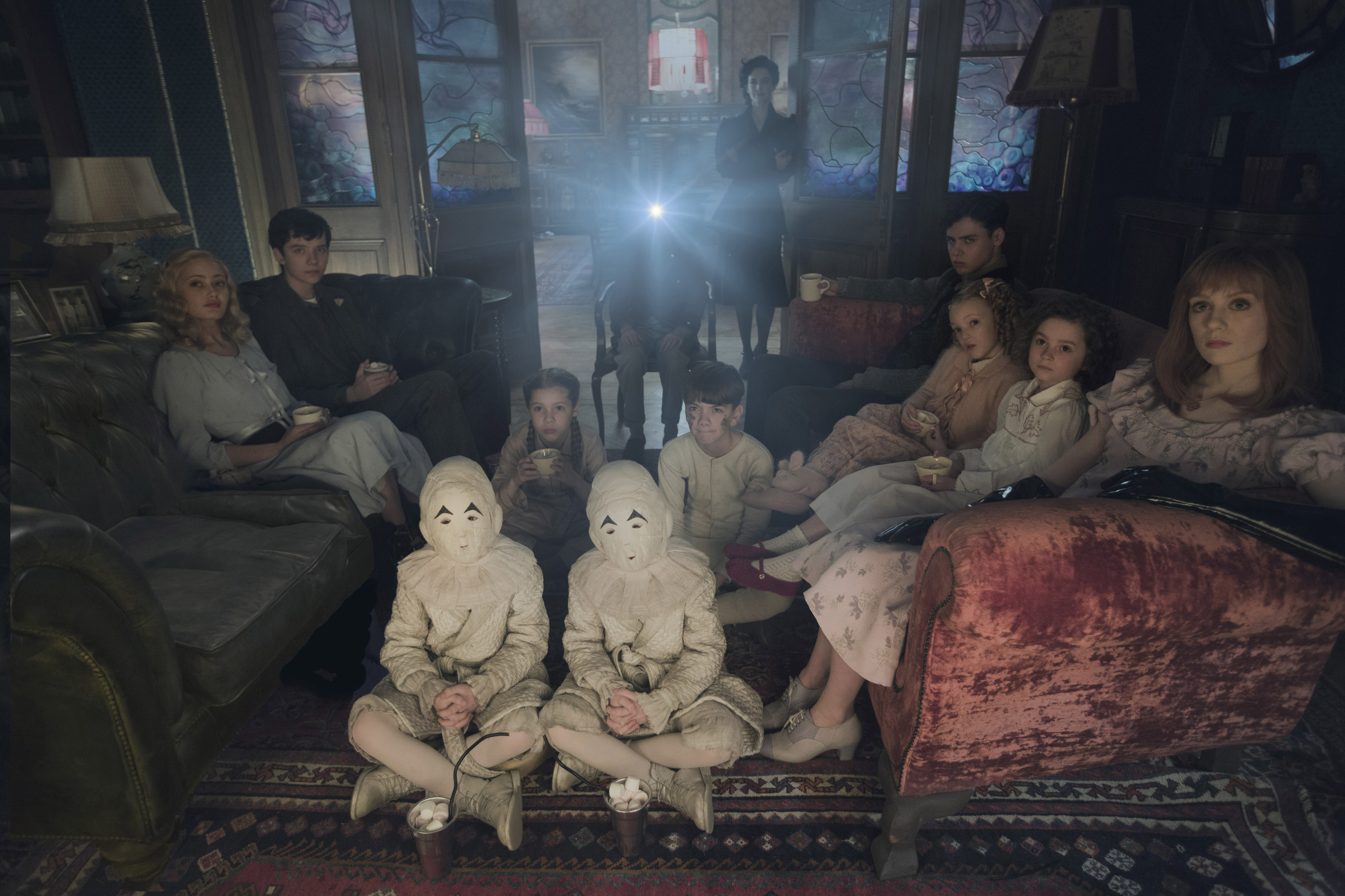 DF-02825modified - Seated on the floor: the twins (Thomas and Joseph Odwell), Fiona (Georgia Pemberton) and Hugh (Milo Parker), Left to right: Emma (Ella Purnell), Jake (Asa Butterfield), Horace (Hayden Keeler-Stone), Miss Peregrine (Eva Green), Enoch (Finlay Macmillan), Claire (Raffiella Chapman), Bronwyn (Pixie Davies) and Olive (Lauren McCrostie) - are the very special residents of MISS PEREGRINE’S HOME FOR PECULIAR CHILDREN. Photo Credit: Leah Gallo.