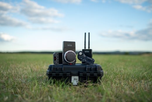 Remote focus controller on a pelican case in the middle of a field.