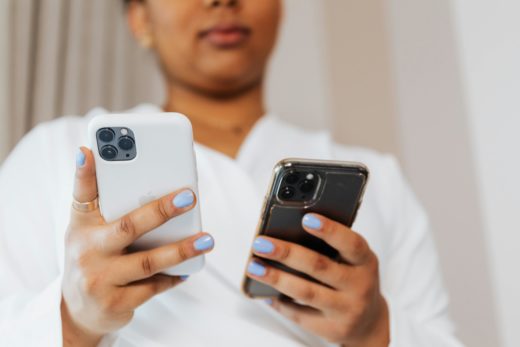 Better ways to control things 2 A person holding two cellphones at once.