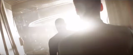 A still from the 2009 Star Trek film with two men silhouetted against very bold lens flare.